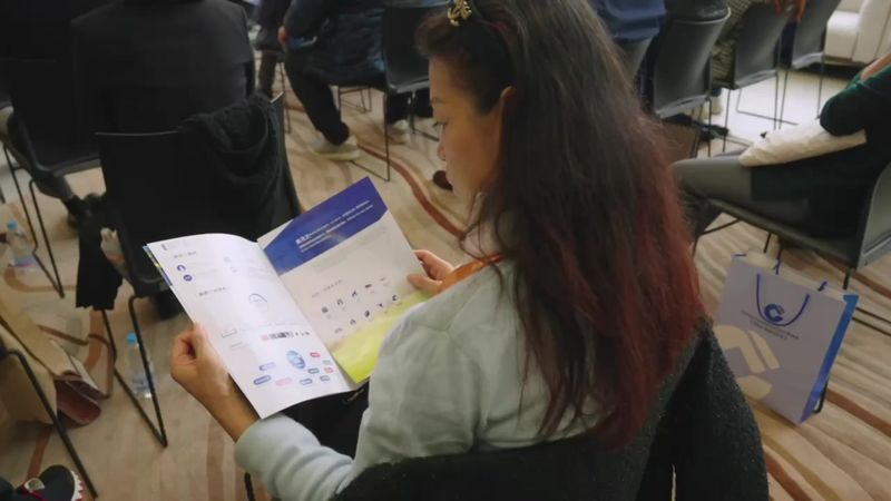 Visitor reading an exhibition programme